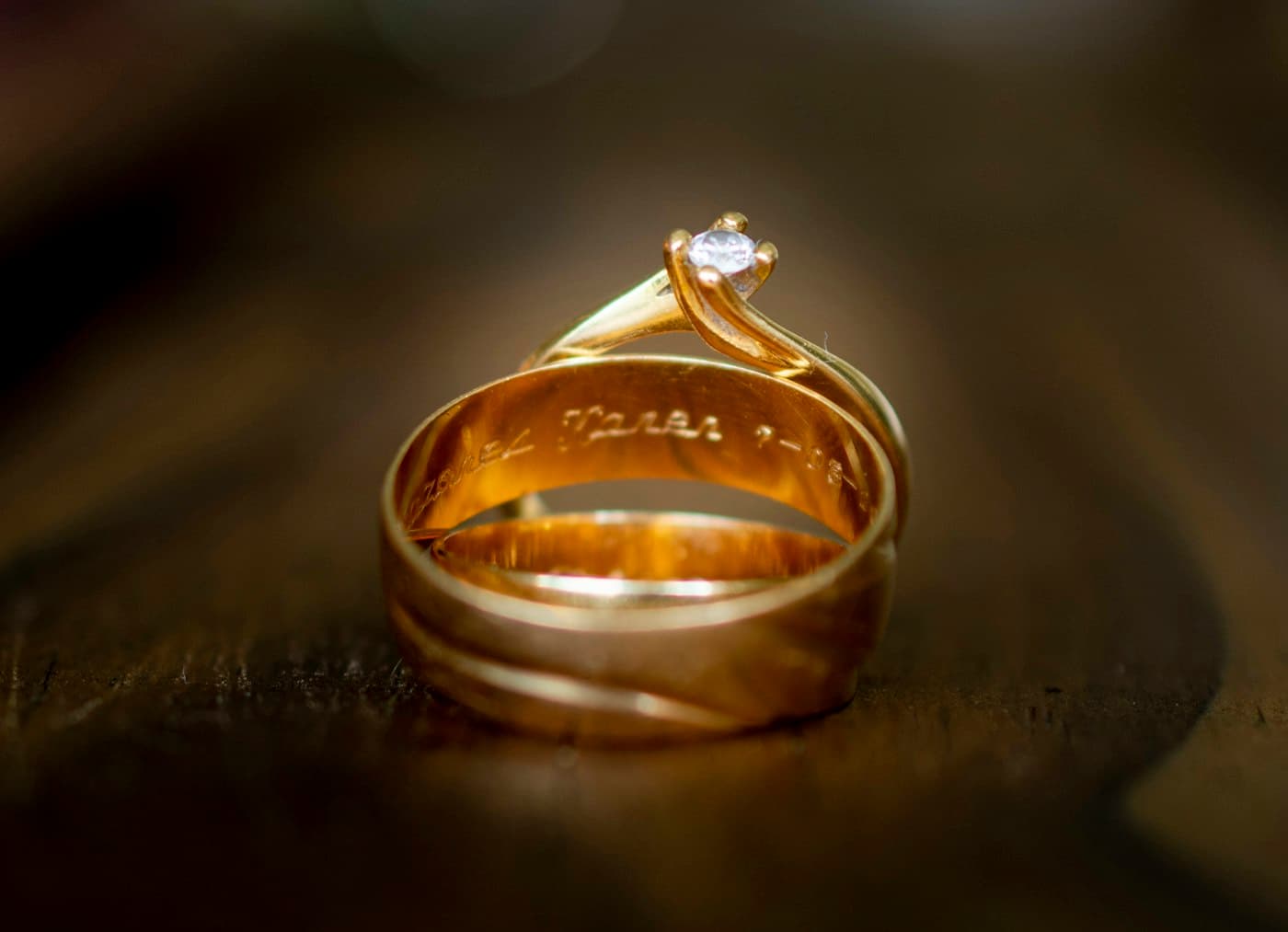 Gold band stacked with a solitaire ring
