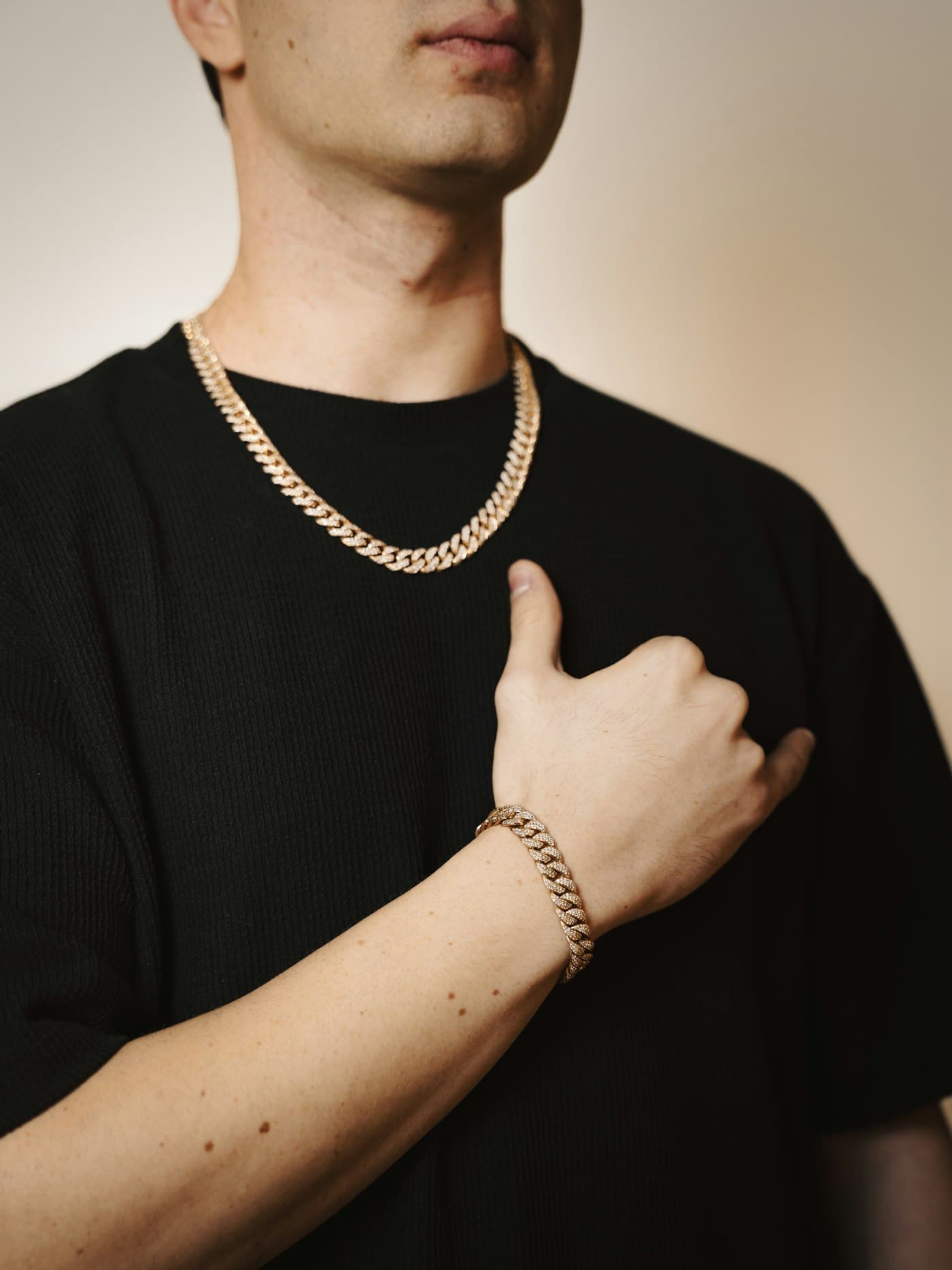 Gold chain and bracelet worn together