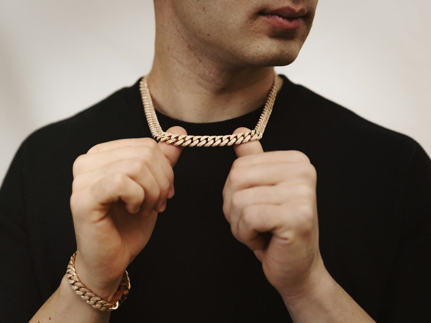 Gold Cuban link chain held at the neck