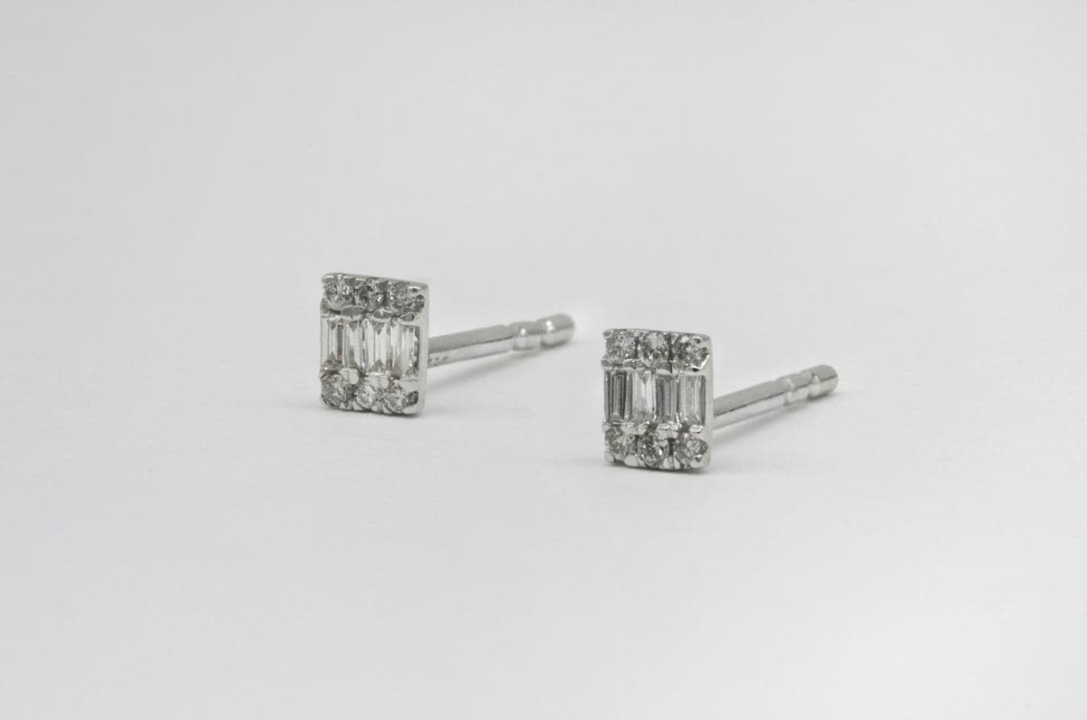 Pair of small rectangular studs with a row of baguettes between rows of round stones, white metal posts