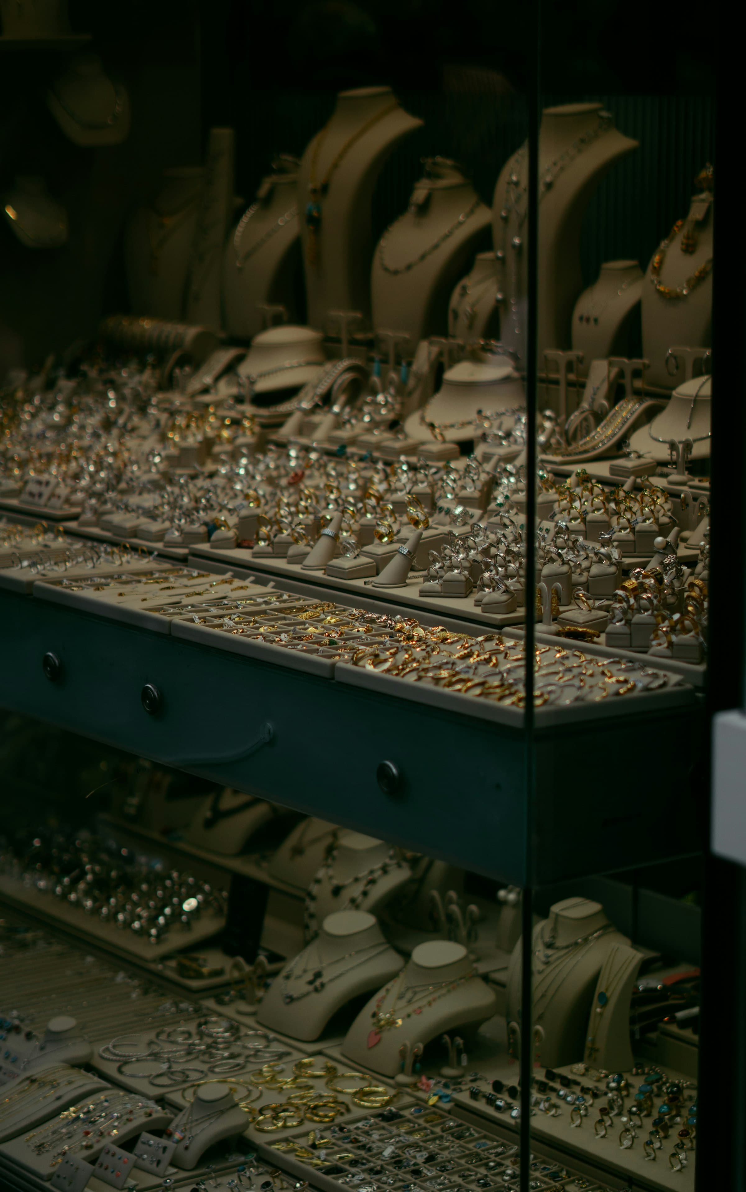 A dark jewelry case lined with rings and necklaces